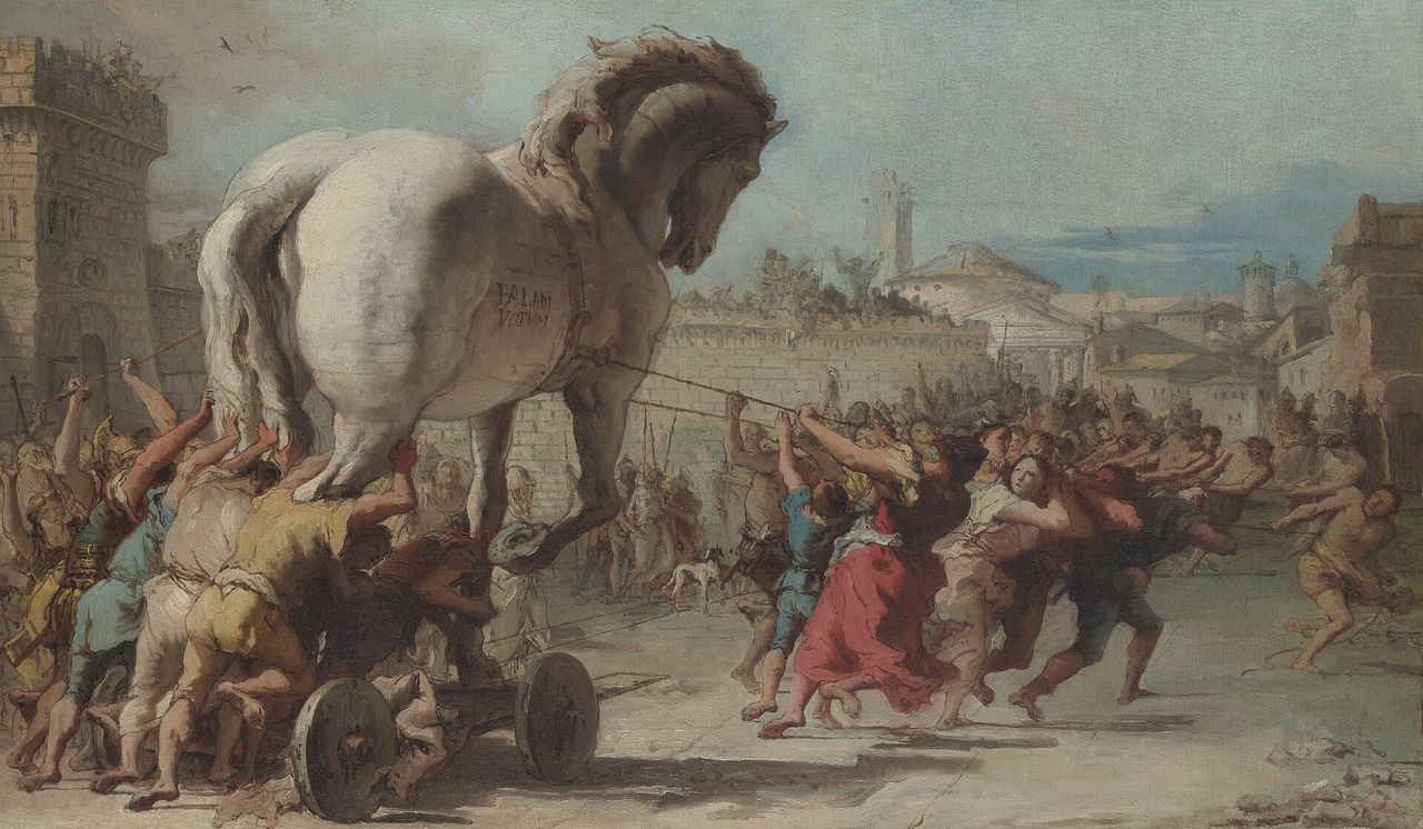 I Troiani trainano dentro le mura un enorme cavallo di legno, in mezzo alla folla in festa.